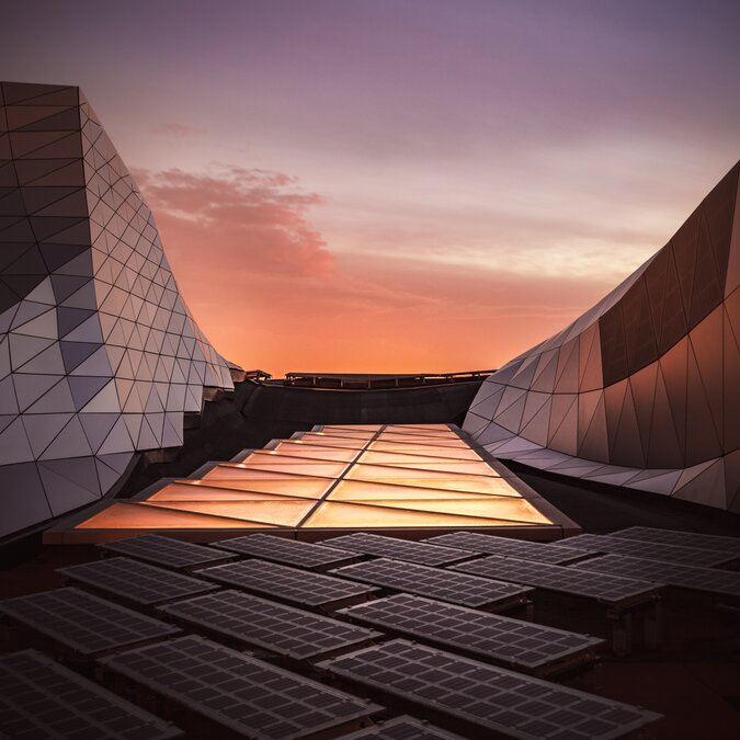 Detail of the Confluence Museum in Lyon with its unique architectural style and modern steel and glass materials. Photovoltaic models and orange light about ecology, warning, electricity, evolution. | © Shutterstock 1559528492