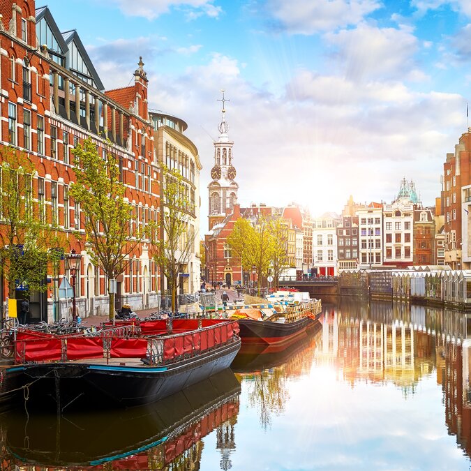 Canal in Amsterdam Netherlands Houses and the River Amstel The famous European landmark Old cityscape at sunset | © Shutterstock 2487675965