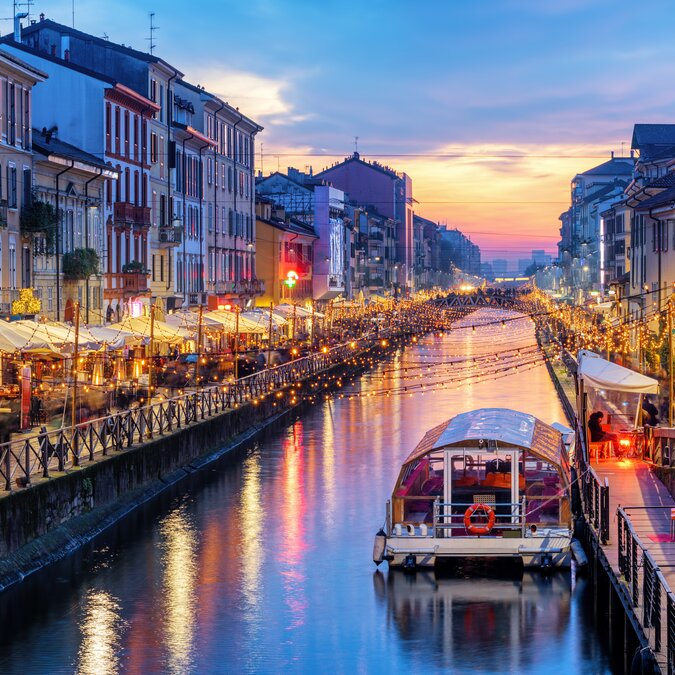 Naviglio Grande Canal in Milan, Italy, a popular tourist area, on a dramatic sunset | © Shutterstock 1647378892